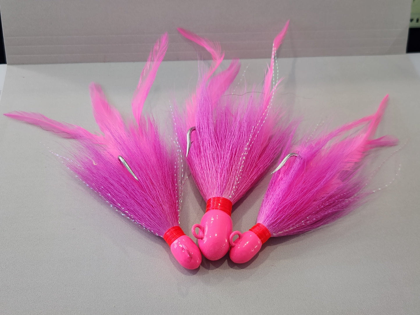 Pink bucktail jig custom with feathers and flash.